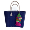 Navy colored woven seagrass and sisal tote with leather handles and multi colored tassel.