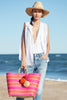 Model on beach with Capri Tote in Pink Mango