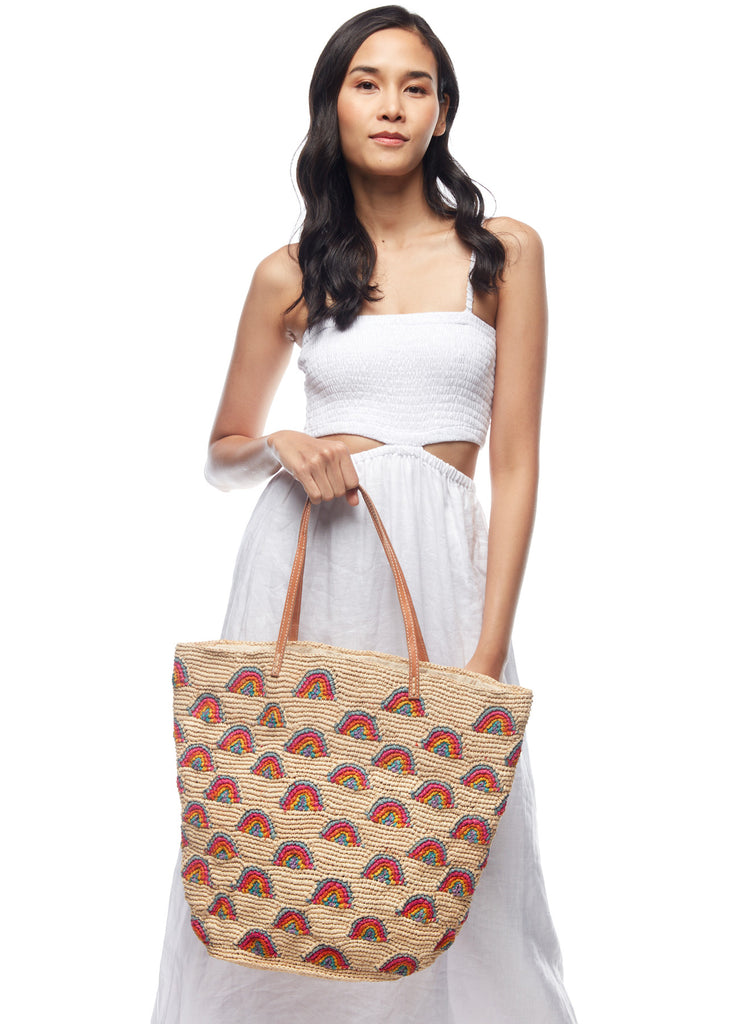 Model holding our Iris tote on a white background