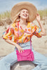 Model on beach wearing Naomi pink