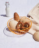 Orange wire sculptural basket with baked goods in it