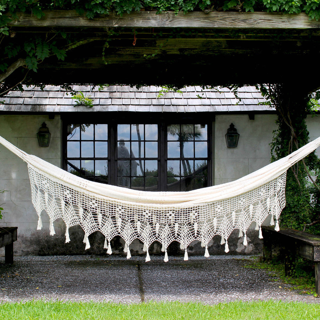 Closer view of hand-knotted natural cotton hammock in backyard setting