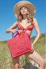 Model on beach with Callie Pink Mango