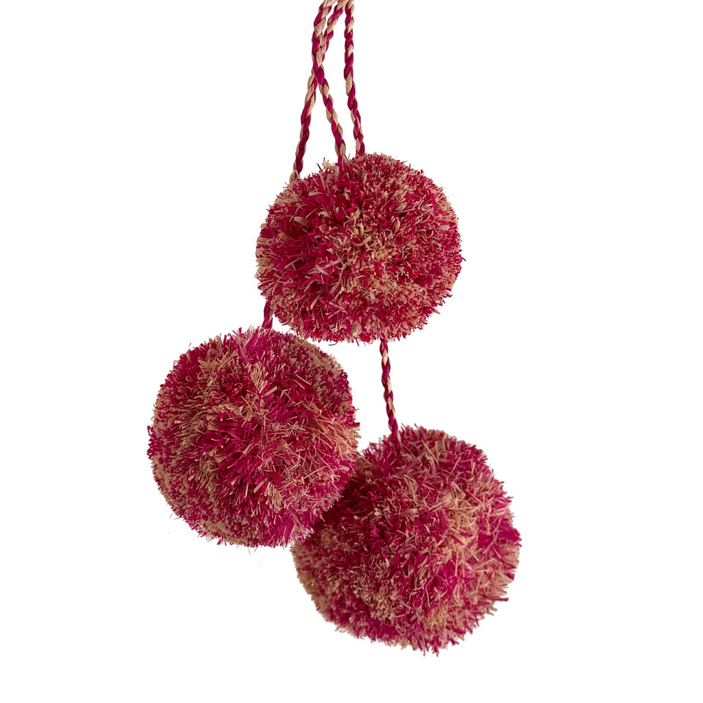 Mottled pink and natural colored pompoms as used on the Caracas tote