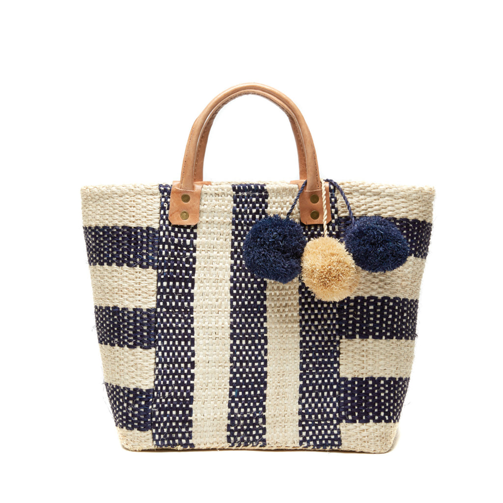 Navy and natural striped woven sisal basket tote with pom poms and leather handles