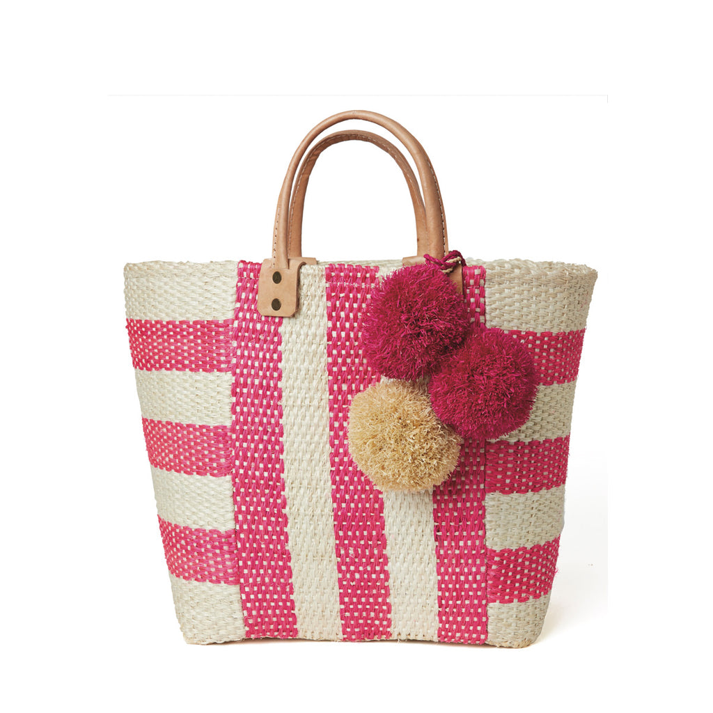 Pink and natural striped woven sisal basket tote with pom poms and leather handles