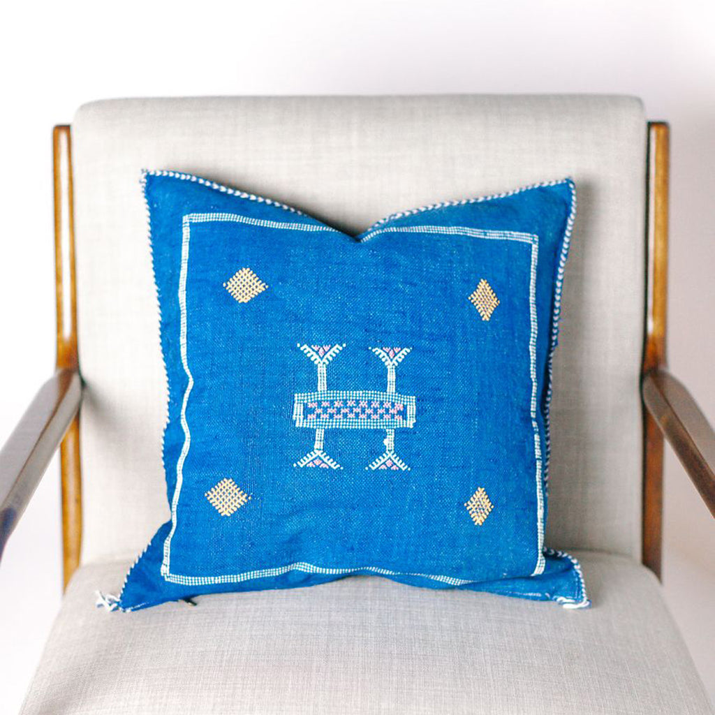 Blue cactus pillow on a chair