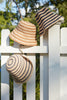 Three Eleni hats on a white fence