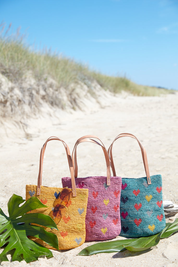Three Amelie totes on the beach