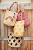 Four kids totes hanging on a wooden door