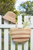 Piper Sand on a fence with Eleni hat 