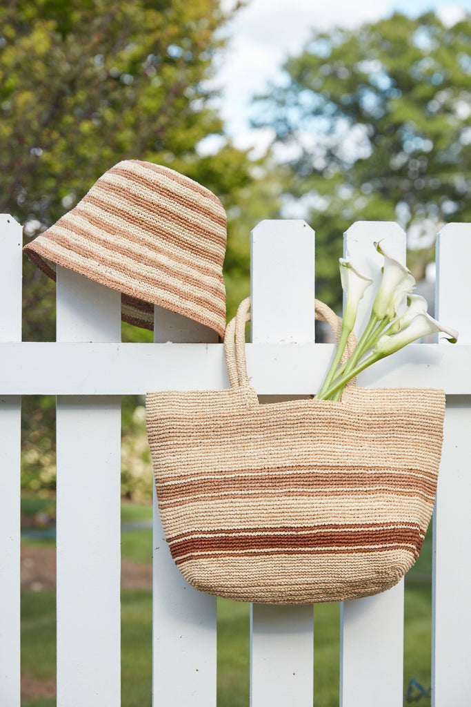 Piper Sand on a fence with Eleni hat 