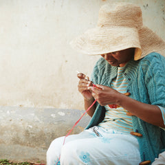Woman crocheting raffia