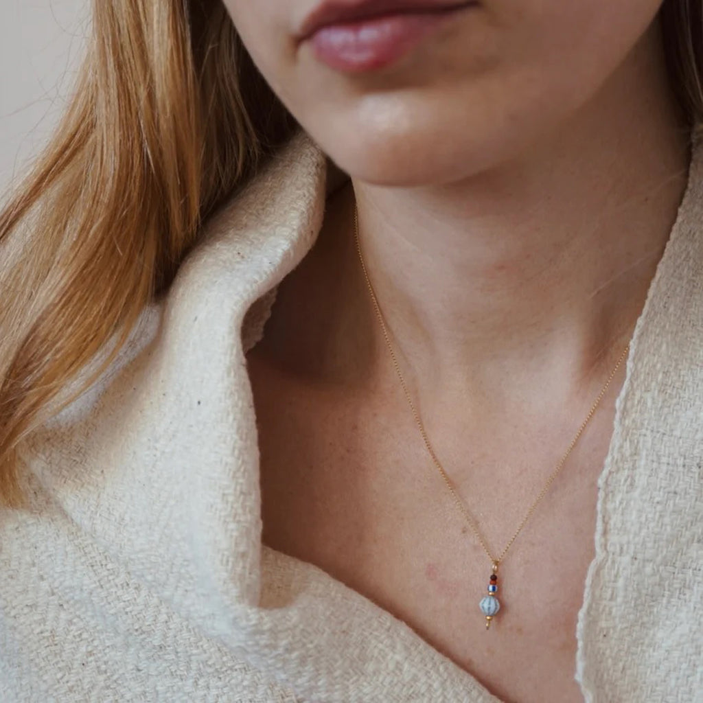 Crop of model's chest wearing the Float necklace