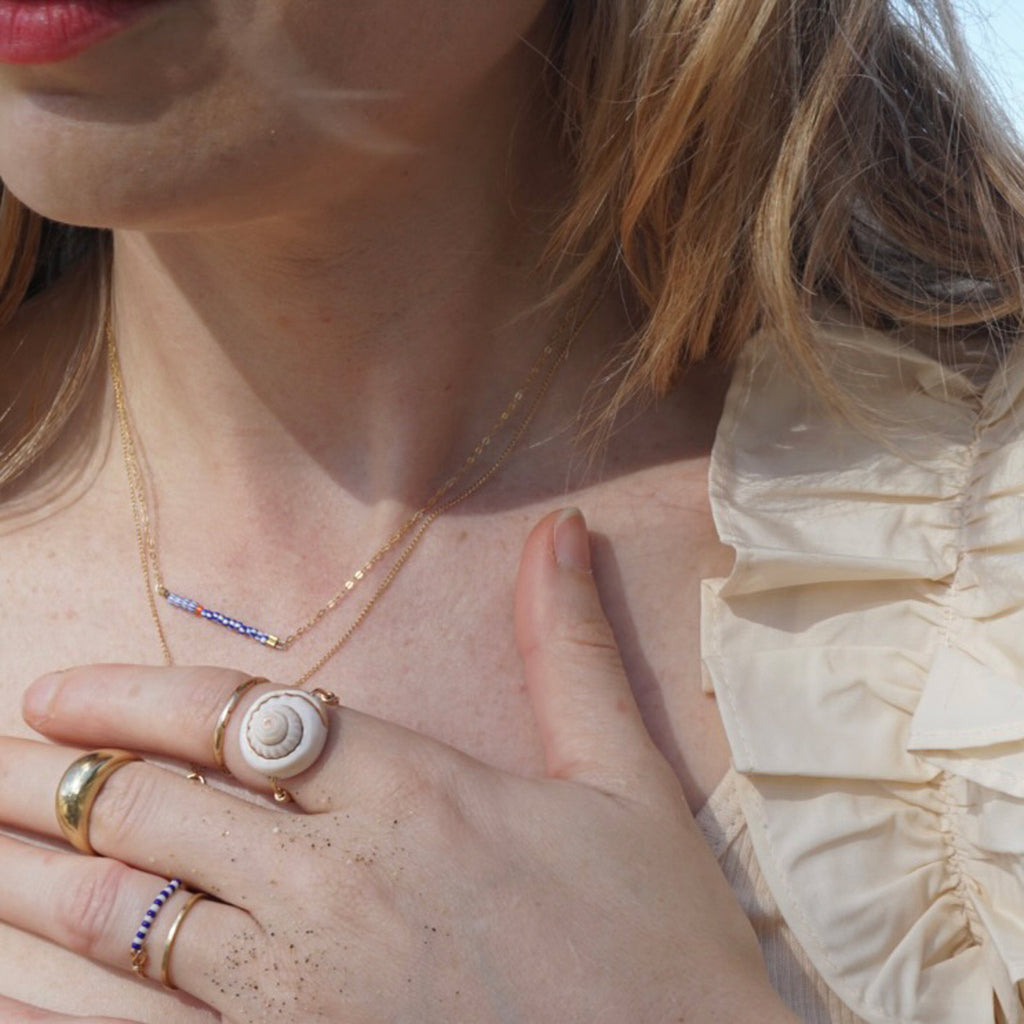 Crop of model's chest wearing the bridge necklace
