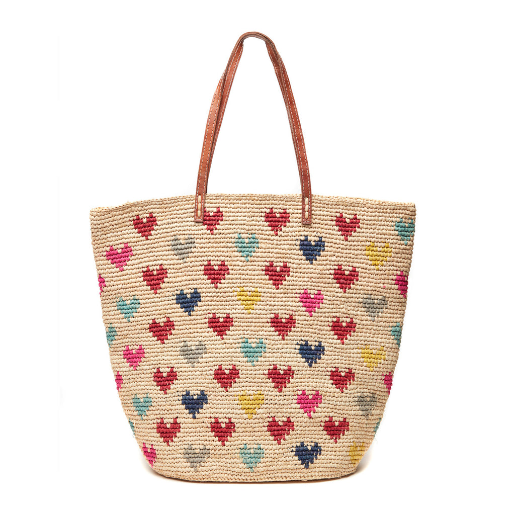 Crocheted carryall with multi colored heart pattern, cotton lining, snap closure, & leather straps
