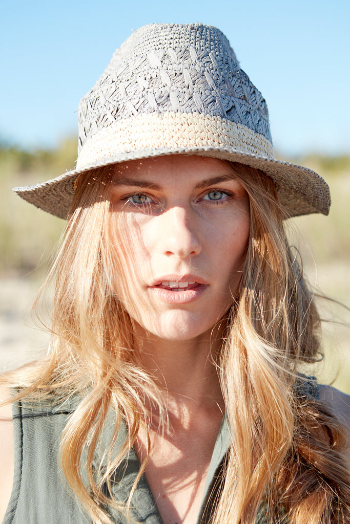 Model wearing dove colored crocheted fedora with natural colored contrast stripe
