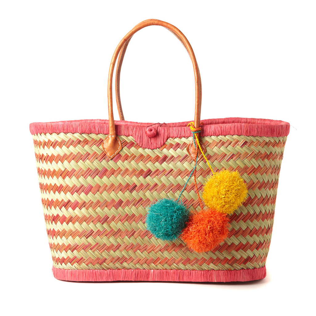 Coral and natural colored seagrass with raffia trim leather handles and tri-color pom poms.