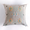 Dove colored square pillow with embroidered design