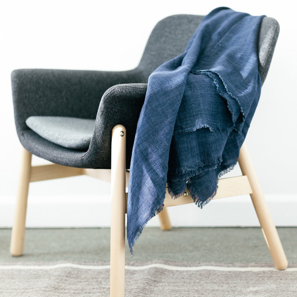 Woven linen throw in stonewashed navy on a chair