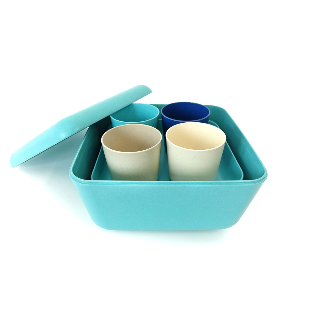 Blue and white and aqua plates and cups and trays in container