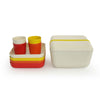 Orange, white, and yellow plates and cups and trays stacked next to closed carrying case