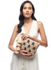 Model holding the Estrella clutch on a white background