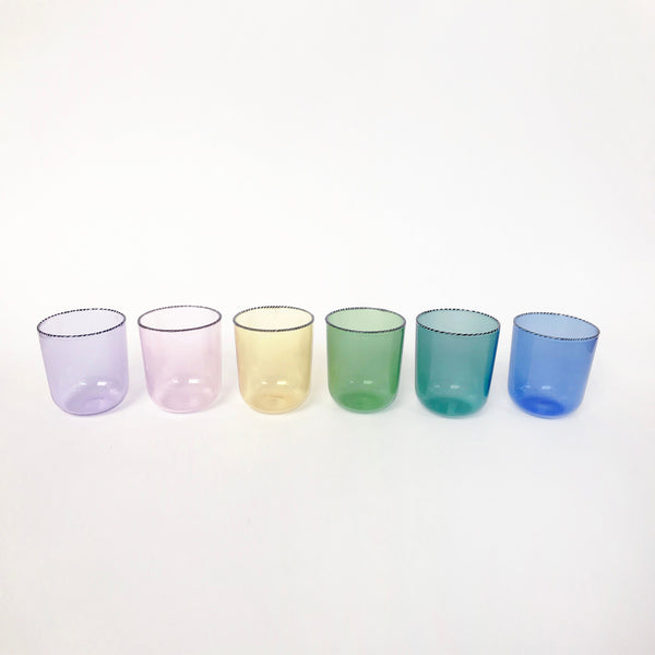 Set of six rainbow drinking glasses on white background