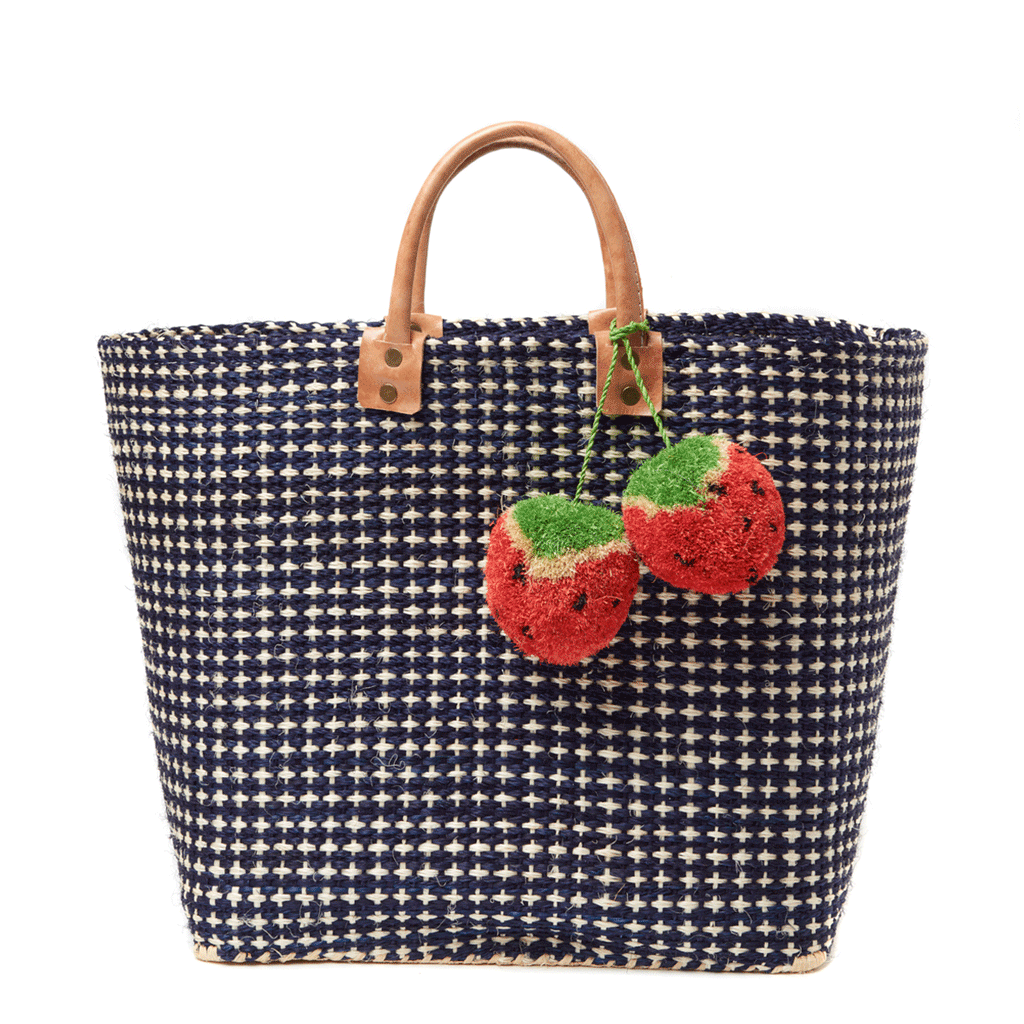 Hadley woven sisal beach tote in Navy with strawberry pom pom charms and leather handles