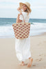 Model on the beach holding our Iris tote over her shoulder