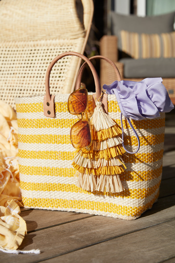 Sahara tote in Sunflower with sunglasses and swimsuit on a deck
