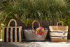 Three totes sitting on a deck with grass background