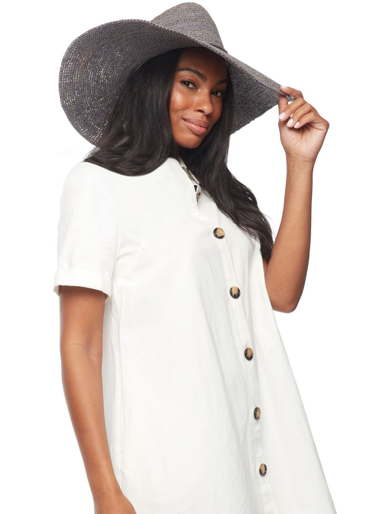 Model on a white background wearing our Jane raffia sun hat in Dove