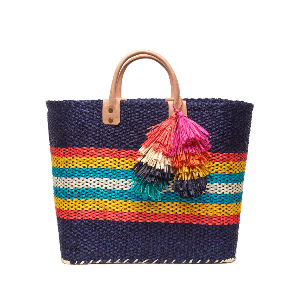 Navy colored, multi-colored striped basket tote with removable tassels and leather handles