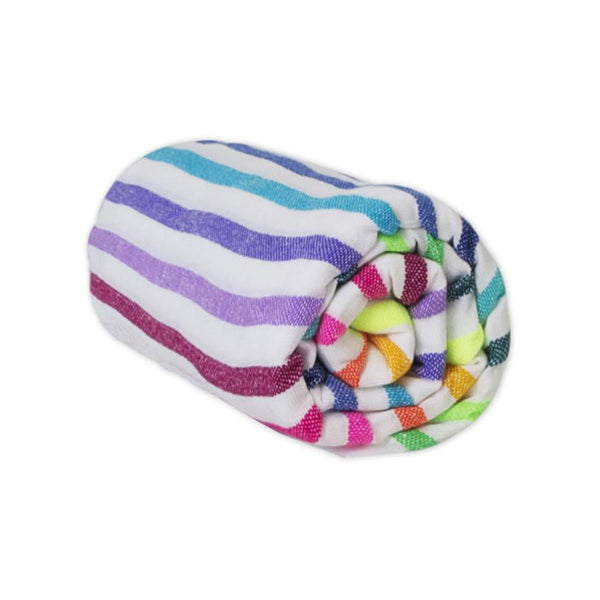 Rolled up rainbow striped beach blanket