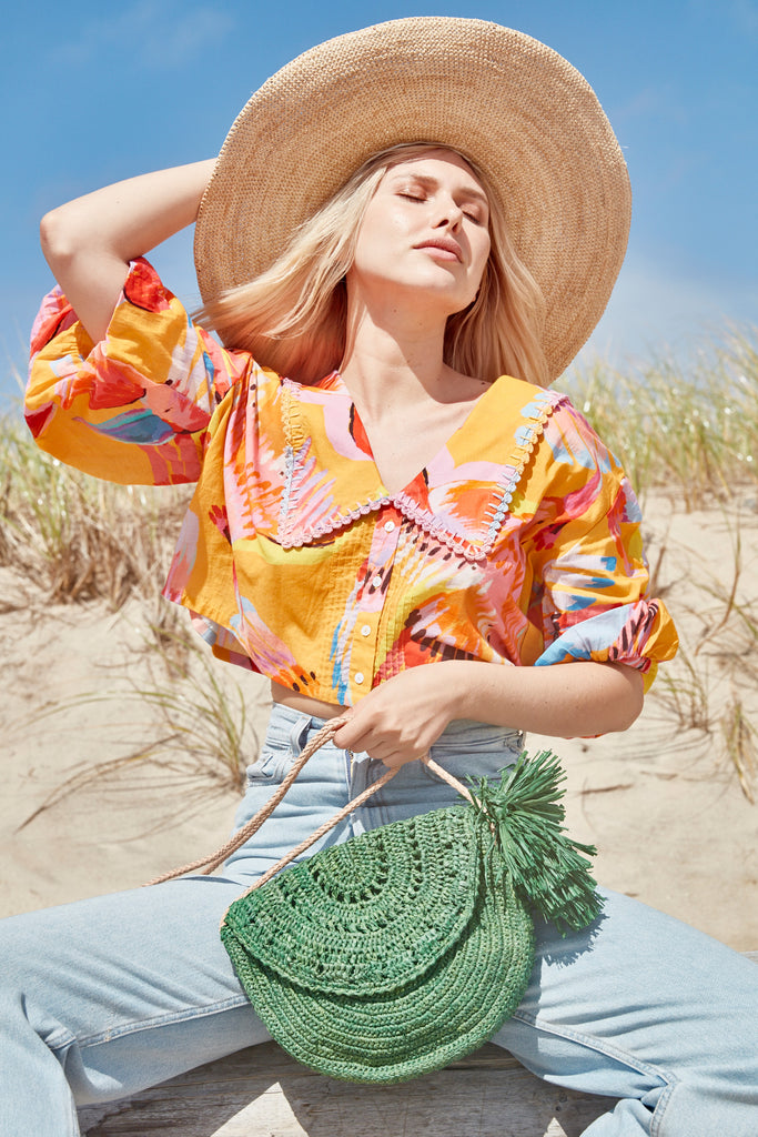 Model on beach wearing Lila Emerald