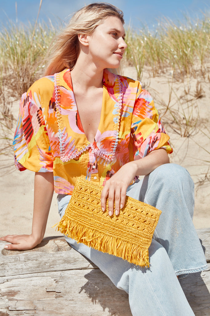 Model sitting on beach with Lisette Sunflower