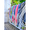 Array of different color turkish towels on a fence rail