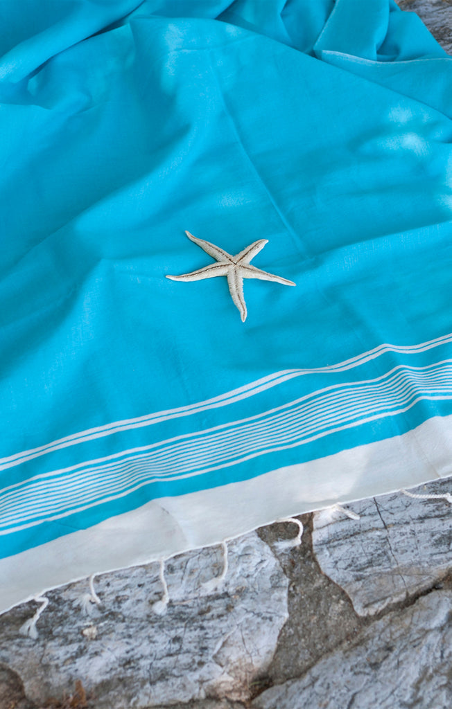 Turquoise colored turkish towel with starfish
