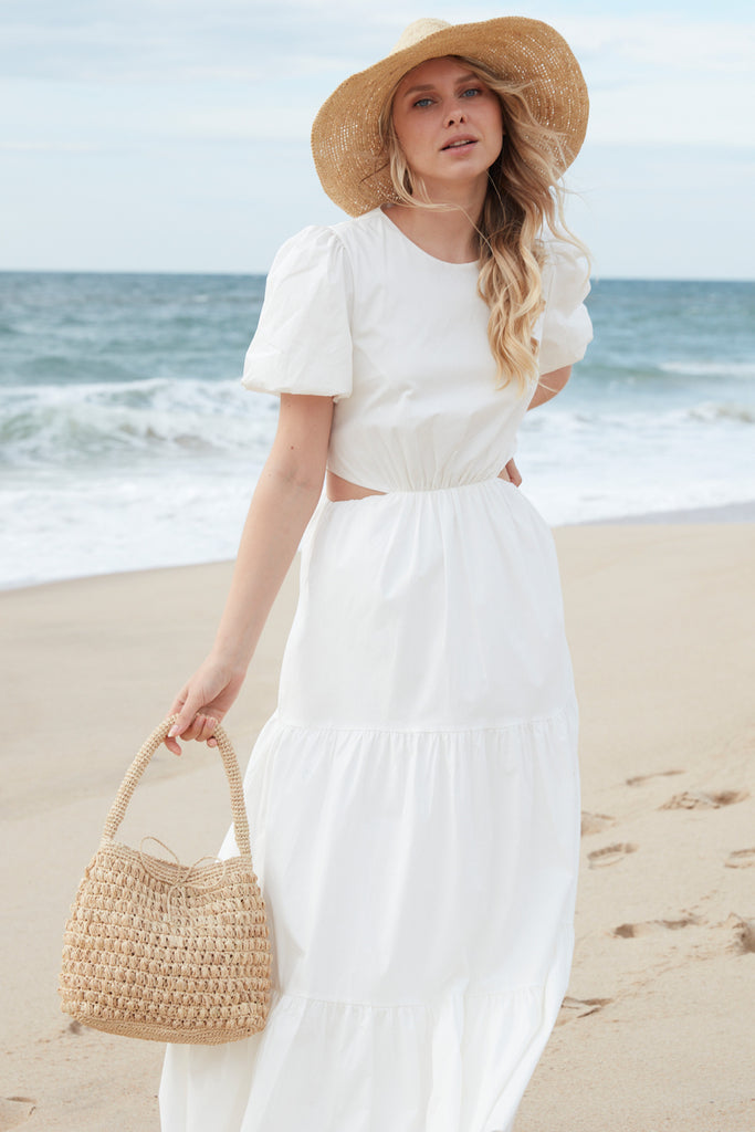 Model on the beach wearing Madelyn in Natural