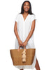 Model on white background wearing our Marley sisal beach tote in Sand color