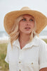 Model wearing natural colored crocheted medium brim fedora with leather tie