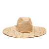 Natural wide brimmed raffia sun hat with navy colored embroidered polka dots and braided cord