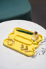 Yellow colored catchall tray with props in it
