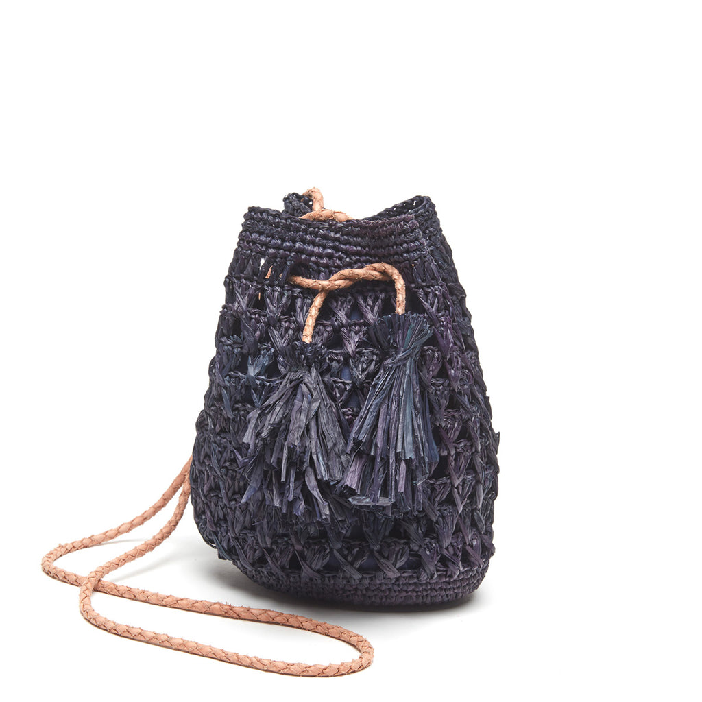 Navy colored crocheted raffia crossbody with cotton lining, leather strap and raffia tassels