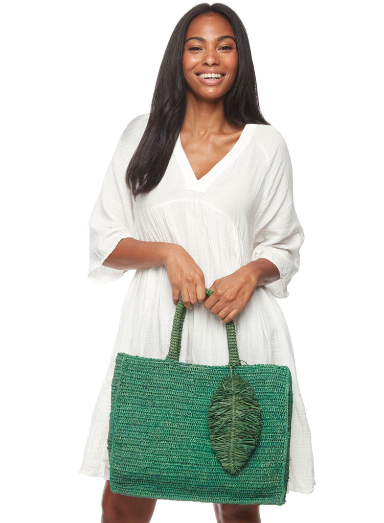 Model on white background holding Ravenna Emerald