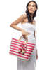 Model on white background holding Sahara tote in Pink
