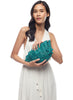 Model holding our Shelley clutch in Aqua on a white background