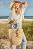 Model on beach holding Skye Natural