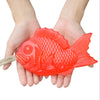 Hands holding red Tai fish soap with a rope handle
